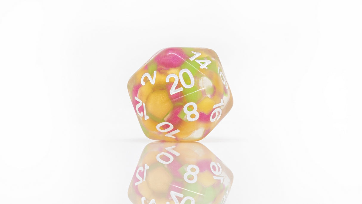 pink yellow and green d20 dice